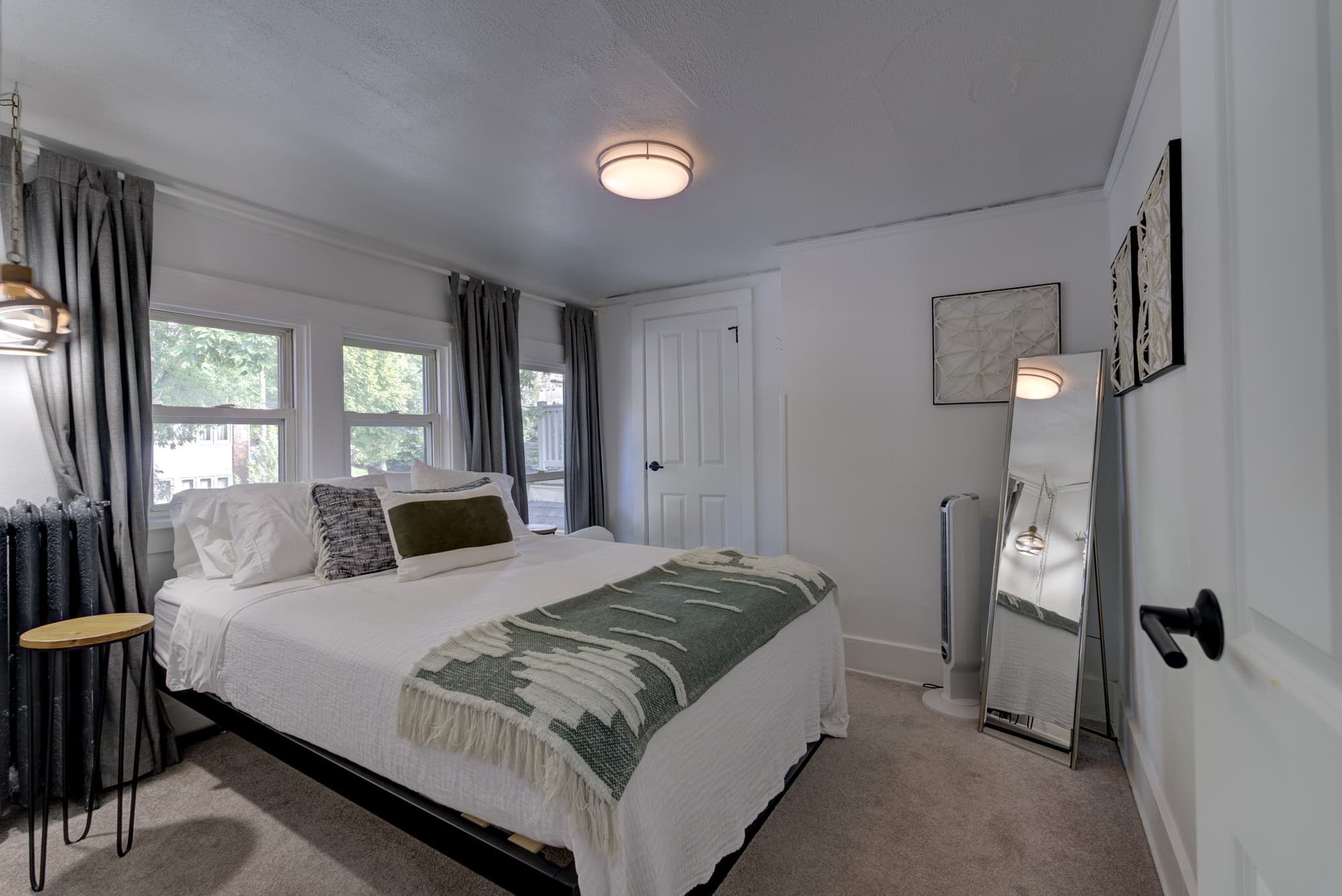 Primary bedroom with queen bed and large windows